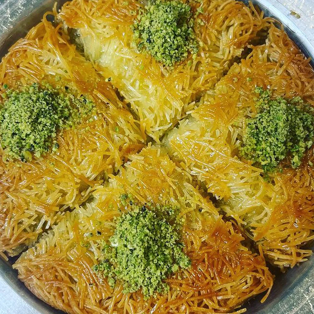 Close-up of golden shredded kadayıf pastry topped with ground pistachio