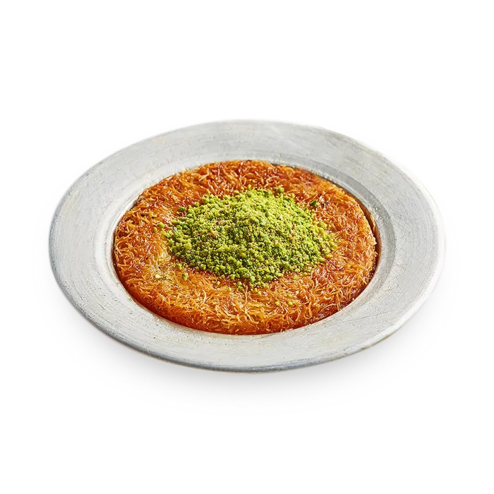 Classic künefe on a silver plate with a crown of ground pistachio