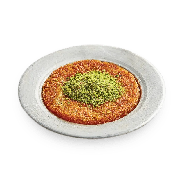 Künefe on a silver plate: crisp golden kadayıf with a crown of ground pistachio